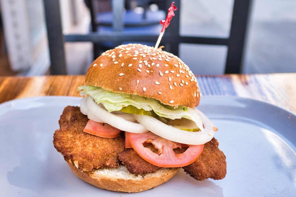 A chicken sandwich on a plate.