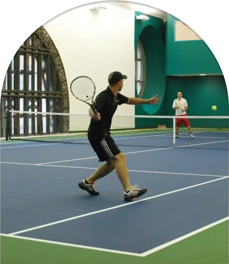 A man hitting a tennis ball with a racket.