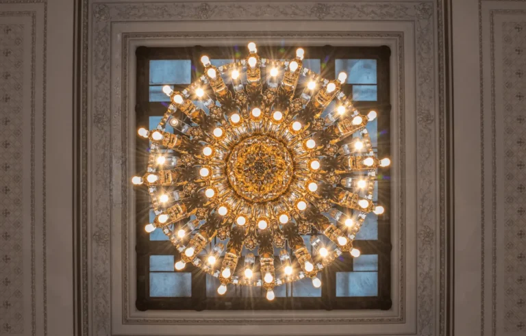 An ornate chandelier hangs from the ceiling of a building.