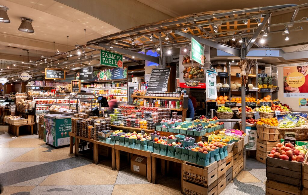 The inside of a grocery store with lots of fruit and vegetables.