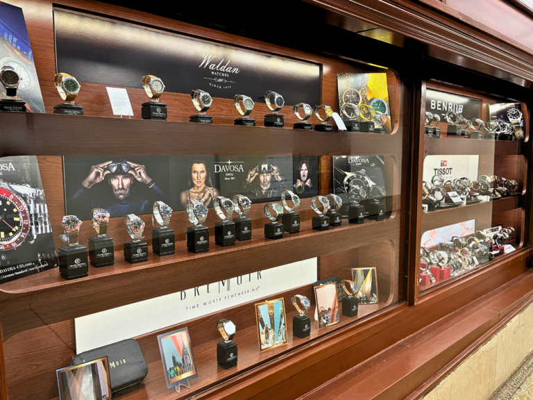 A display of watches in a wooden case.
