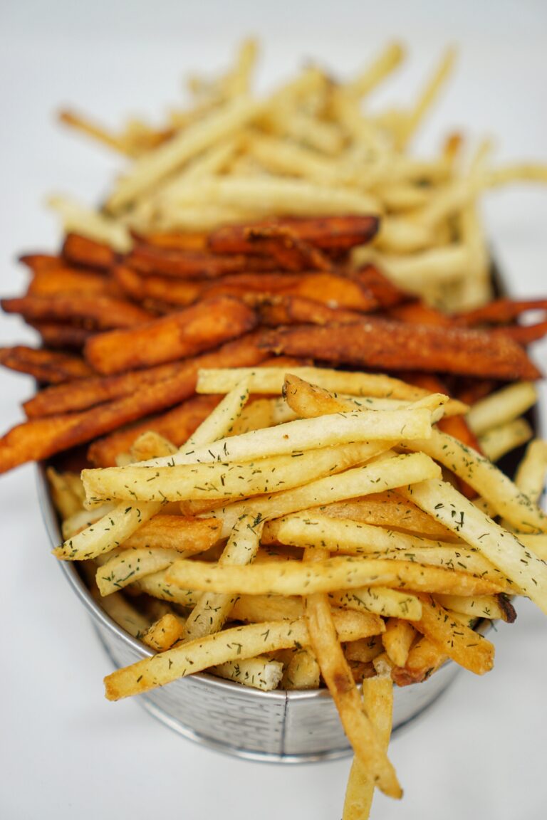 Sweet potato fries in a metal bowl.