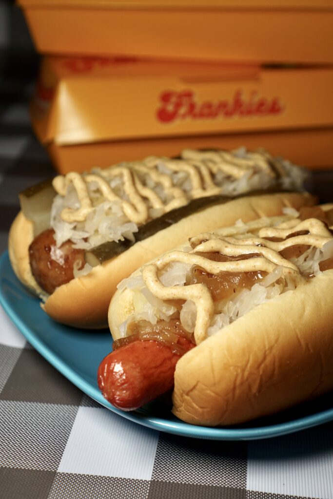 Two hot dogs on a blue plate.