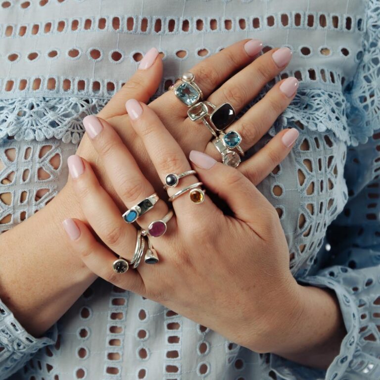A woman's hands with several rings on them.
