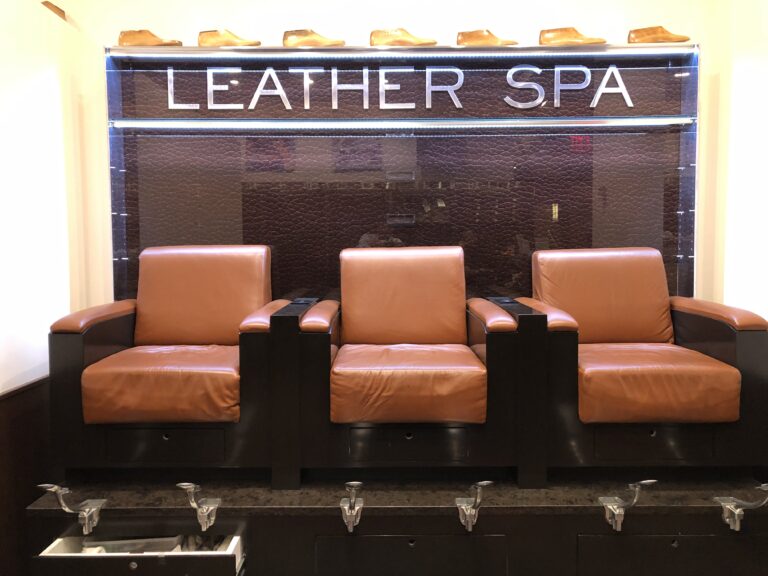 Three leather chairs in front of a sign that says leather spa.