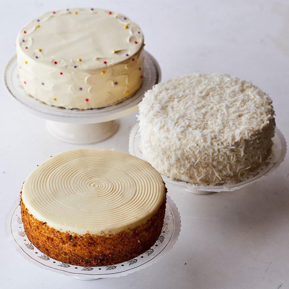 Three cakes sitting on top of a white plate.